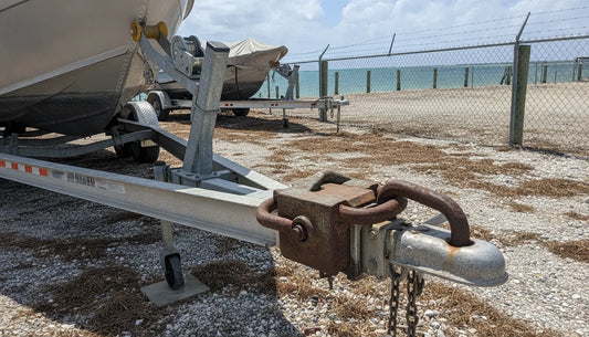 Boat trailer secured in a marina storage lot