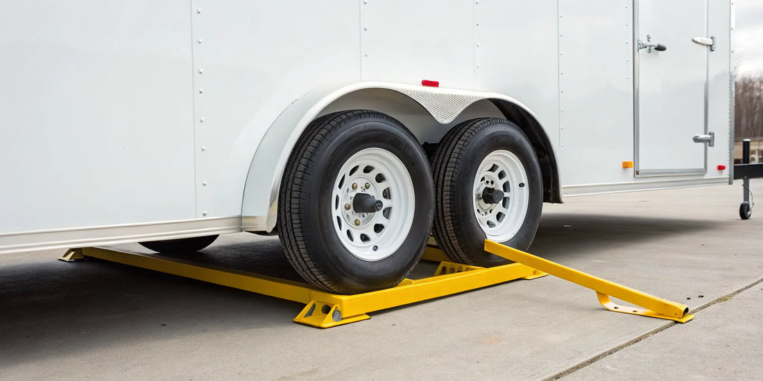 One of the best wheel locks, a heavy-duty yellow clamp, securing a trailer's dual wheels.