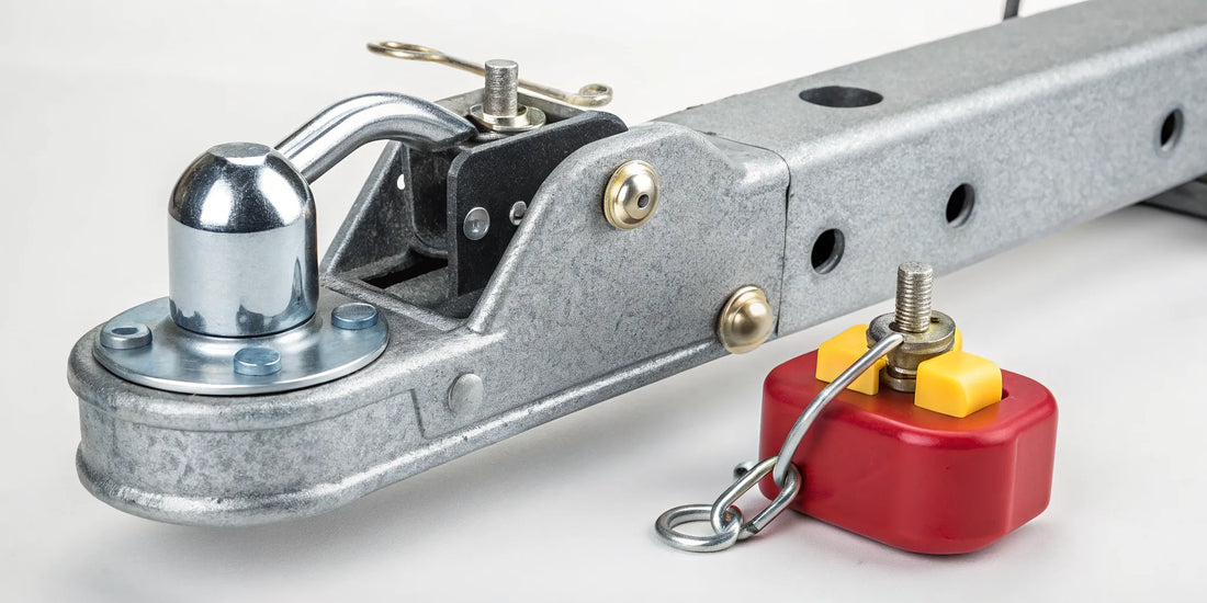 A heavy-duty lock securing a trailer coupler from theft.