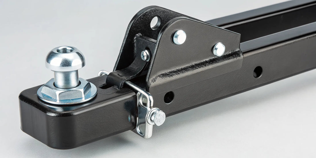 A trailer tongue lock pin securing a trailer coupler to prevent theft.